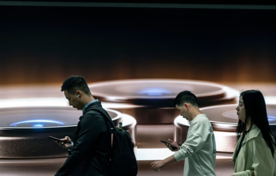 Люди проходять повз реклами iPhone 16 на станції метро в Шанхаї Фото: Qilai Shen/Bloomberg